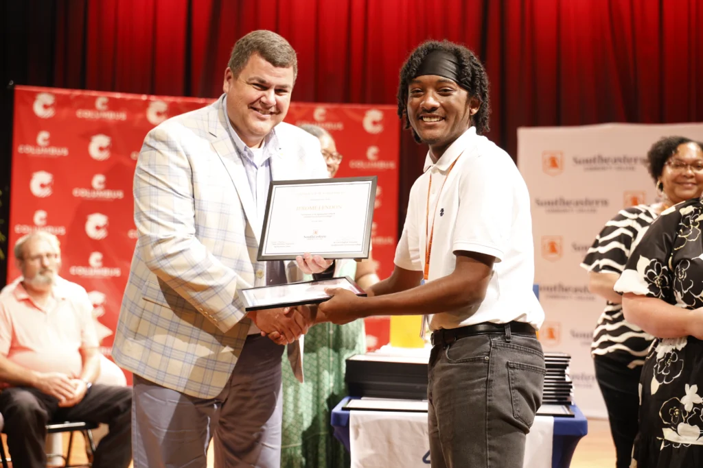 dr. jenkins awarding certificate at camp graduation