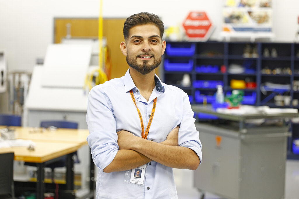Arturo Jones standing in an electrical engineering lab.