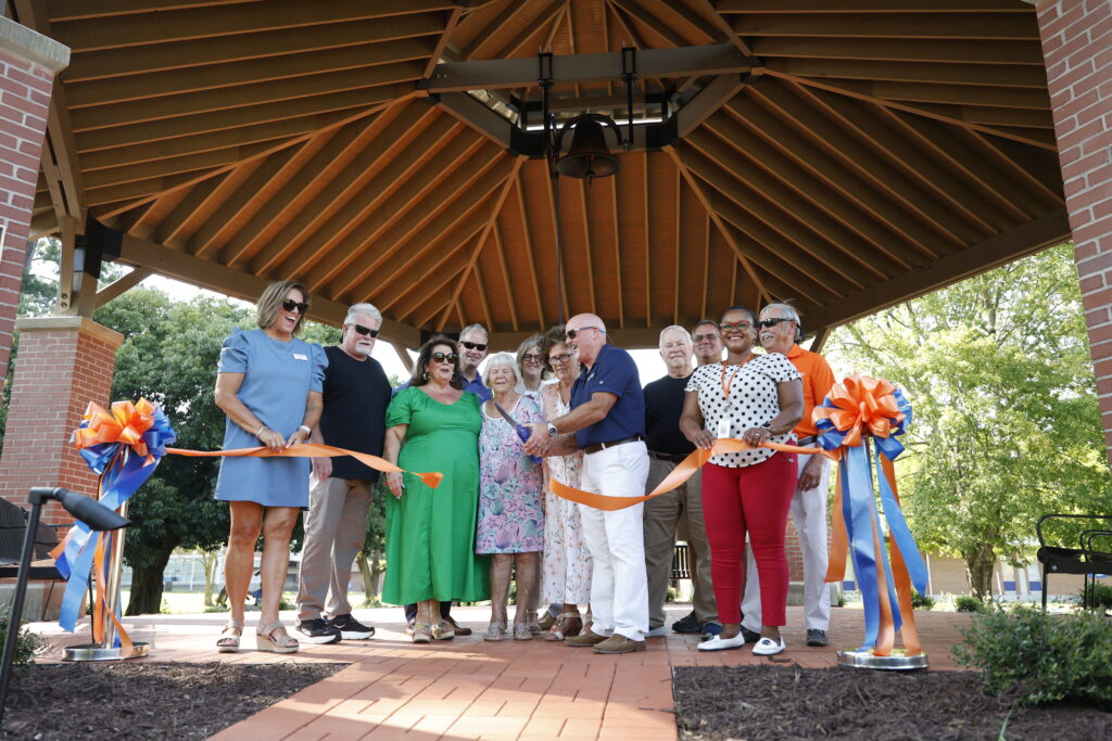 SCC leadership and community members cut the ribbon under the Bell Pavilion during the ribbon-cutting ceremony.
