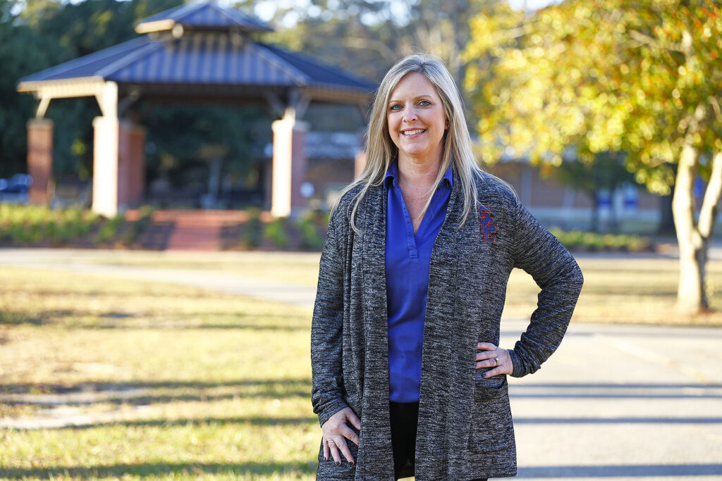 Kim White stands in front of the Chadbourn Bell Pavilion.