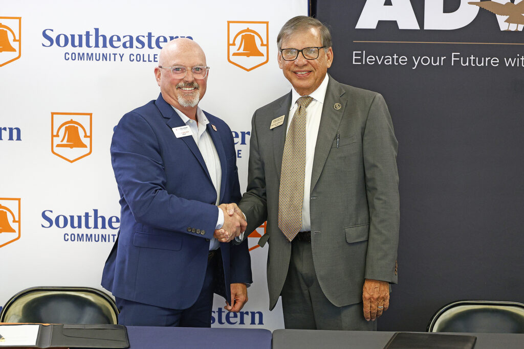 SCC President Dr. Chris English shakes hands with Dr. Robin Gary Cummings.