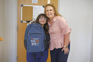 NCReconnect Student holding Better Skills Better Jobs backpack with SCC AVP, Angela Ransom