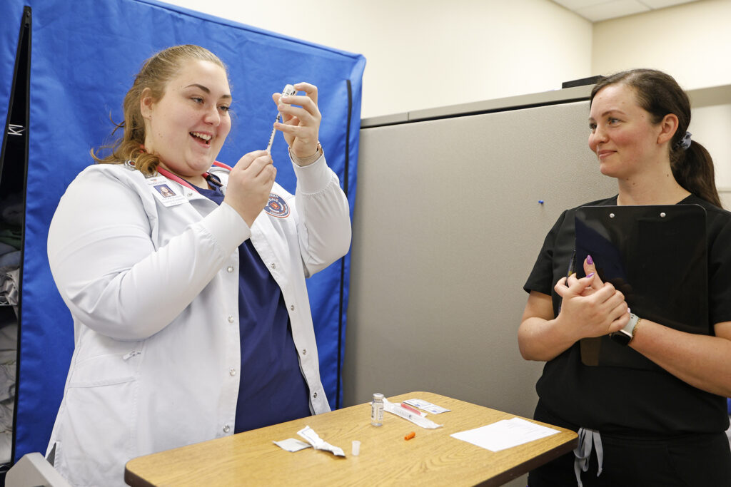 An LPN students gets hands-on experience with needles and administering medication in the nursing sim lab at SCC.