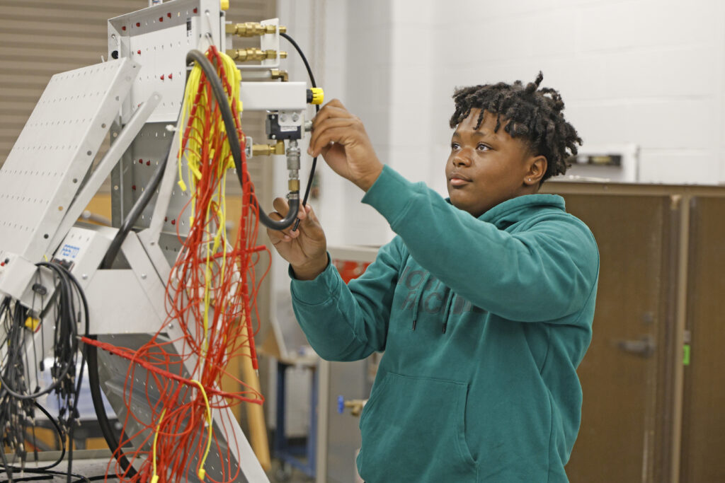 Summer Camp student participates in hands-on engineering activity