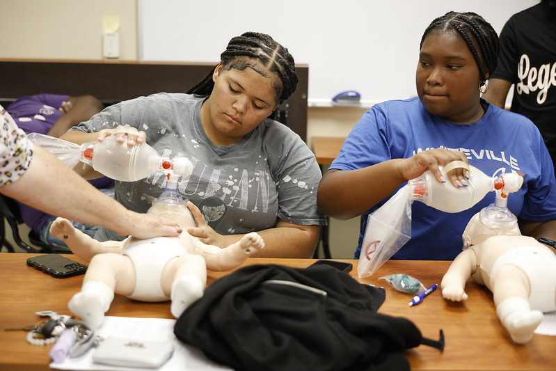 Student participating in CPR activity for ETS Summer Camp