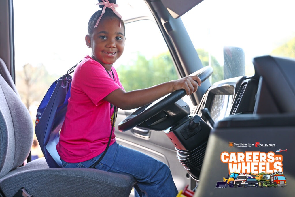 A student sits in the driver's seat of SCC's 18-wheeler truck used for truck driver training at Careers on Wheels on March 23.