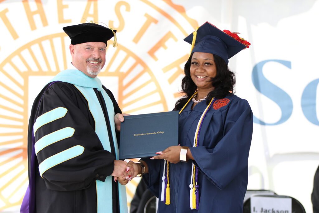 Brianna Hampton at graduation 2025 with Dr. English