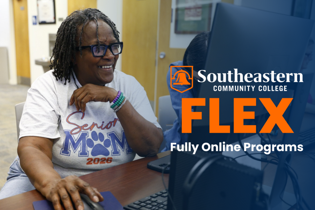 SCC Adult Learner Student sitting at computer in library. SCC FLEX - Fully Online Programs.