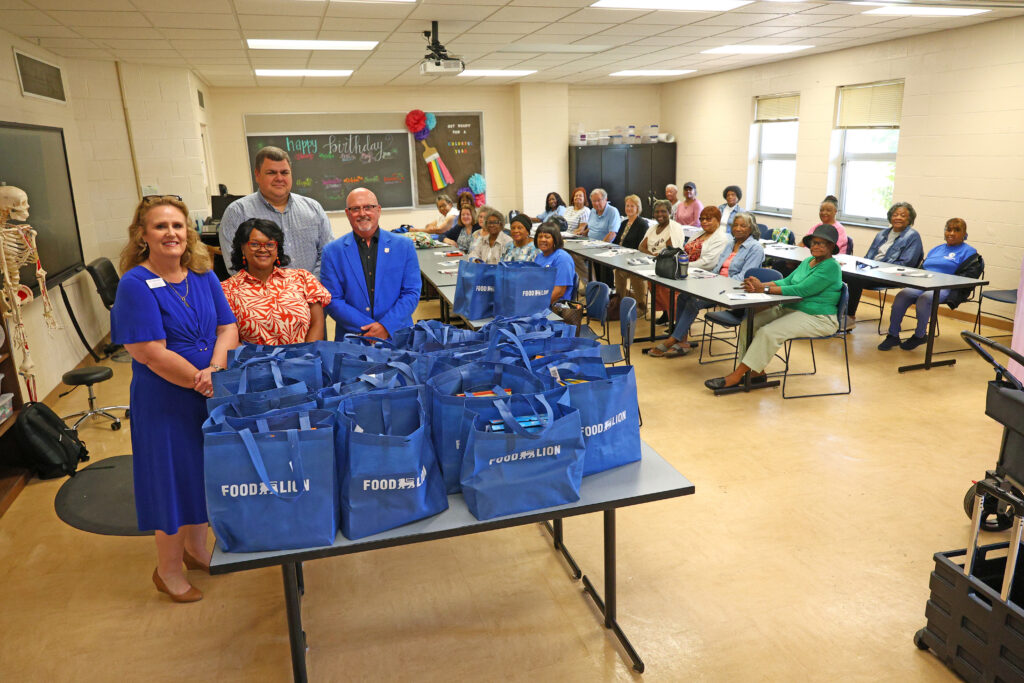 SCC leadership stands with the AmeriCorps Seniors RSVP Basic Skills class participants at SCC.