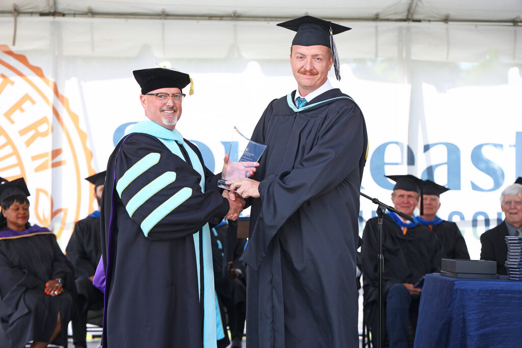Nicky Hobbs accepts his award from Dr. Chris English at the SCC graduation ceremony.