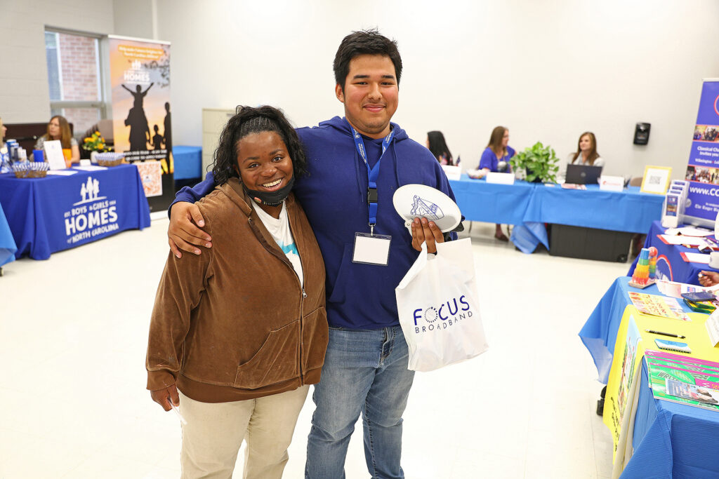 Two students stand together in T-building during the Career Expo and Apprenticeship Day event.