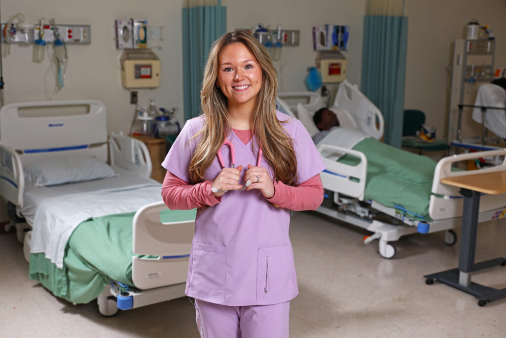 Alex Barton stands in a nursing lab at SCC.
