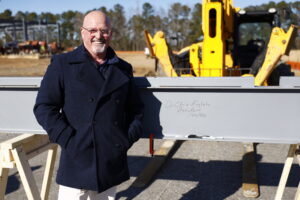 Dr. English signing a pole for the STEM building