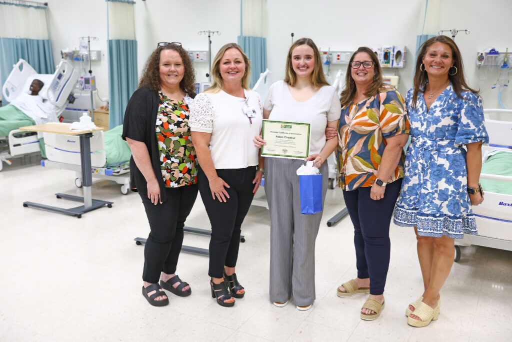 CRHS and SCC employees stand with Aidan Chestnutt (center) after her DAISY Award presentation.