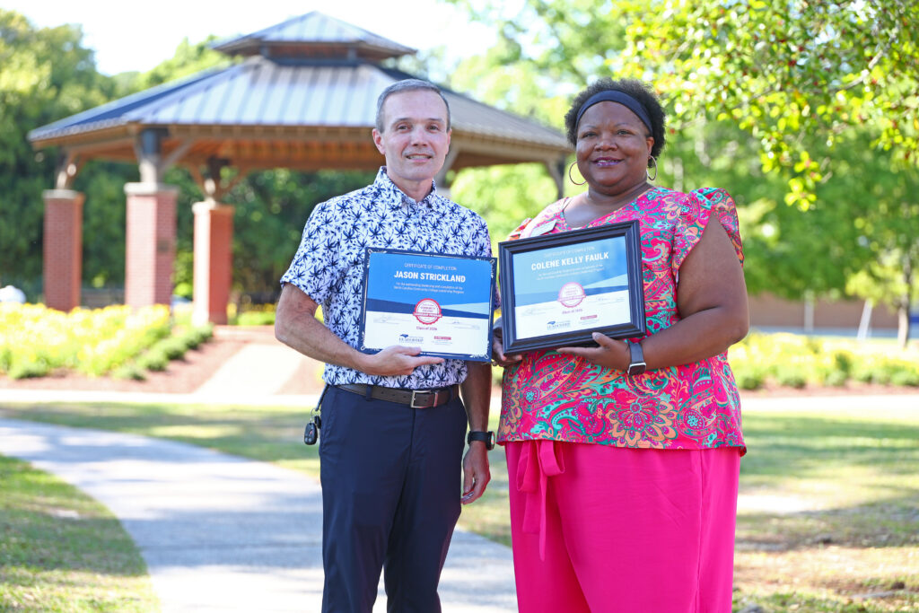 Jason Strickland and Colene Faulk hold their Leadership certificates.