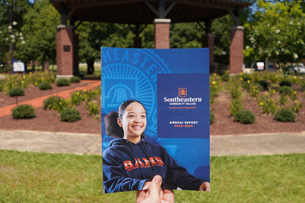 Annual Report cover in front of the Chadbourn Bell on SCC's Campus