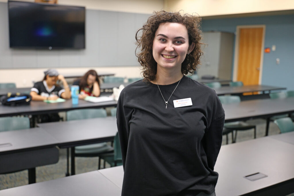 SCC's new psychology instructor, Kate Geisinger, stands her classroom after class.