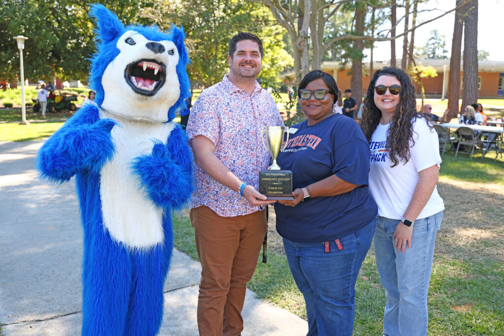 Colene Faulk awards the Junior Day trophy to Whiteville High School for showing the most school spirit.