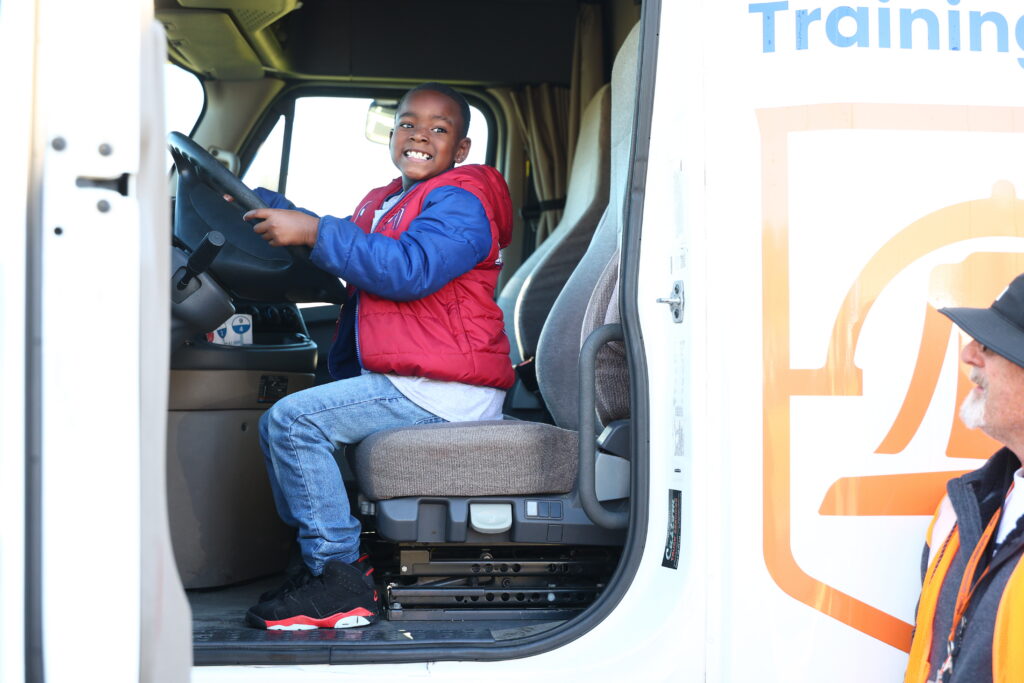 A student hops in the front seat of an 18-wheeler truck used in SCC's Truck Driver Training program.